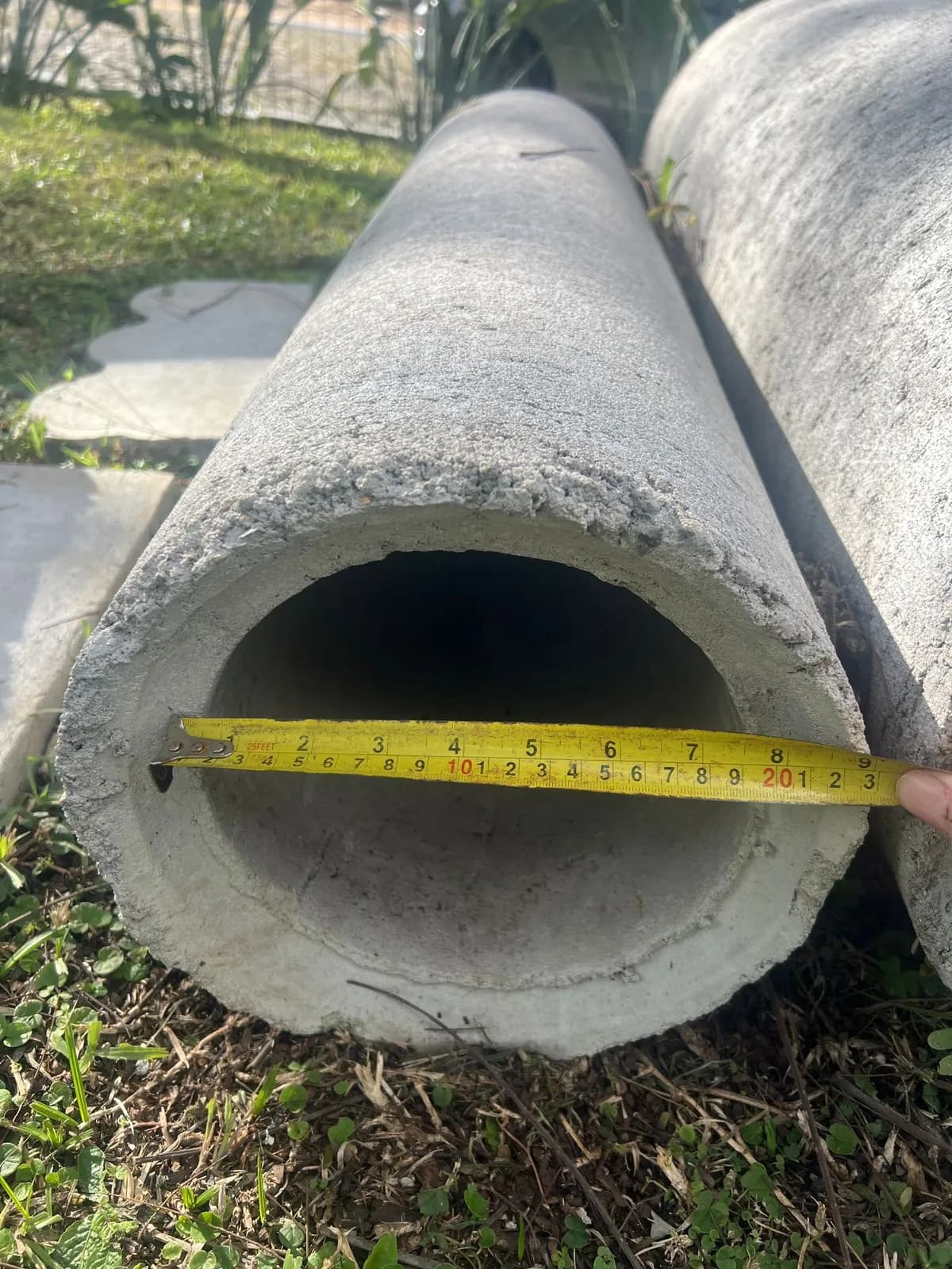 Tubo de concreto com trena medindo o diâmetro interno
